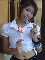 Sexy schoolgirl Thai baby named O sucks a lolipop and shows off her bald pussy